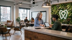 Treatment coordinator and patient reviewing a treatment plan together on a tablet at checkout.