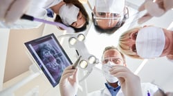dental team working on a patient in a dental clinic