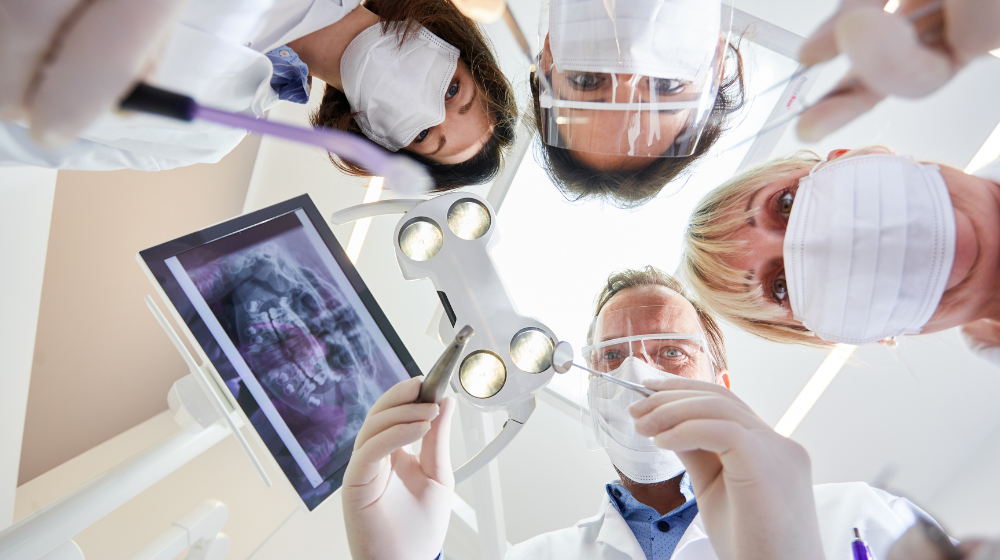 dental team working on a patient in a dental clinic