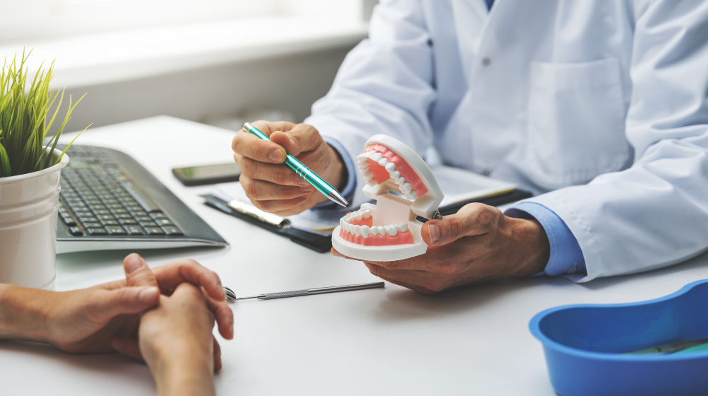 dentist and patient discussion about planned teeth treatment in dental clinic office