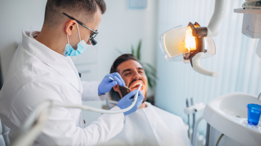Dentist treating a patient in a fee-for-service dental practice focused on personalized care.